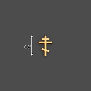 May include: A gold-colored Orthodox cross pendant, measuring 0.8 inches in height. The cross features a three-bar design, with a top horizontal bar, a longer middle bar, and a slanted lower bar. The pendant is shown against a dark gray background.