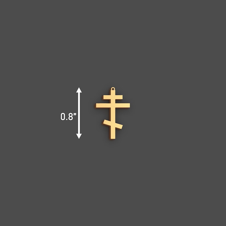 May include: A gold-colored Orthodox cross pendant, measuring 0.8 inches in height. The cross features a three-bar design, with a top horizontal bar, a longer middle bar, and a slanted lower bar. The pendant is shown against a dark gray background.