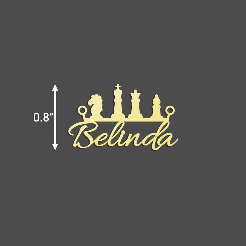May include: Gold-coloured metal cutout of a chess piece crown with the name Belinda underneath. The crown is 0.8 inches tall.