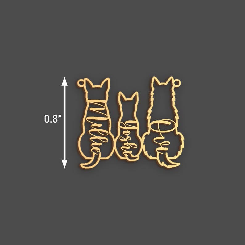 May include: Three wooden dog ornaments, each with a different name: "Millie", "Joshie", and "Ollie". The ornaments are approximately 0.8 inches tall and are cut in the shape of dogs sitting down. The names are in a cursive font.