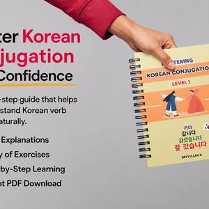 May include: A spiral-bound workbook titled Mastering Korean Conjugation Level 1 with a yellow cover featuring illustrations of two people in traditional clothing, Korean text, and a small South Korean flag sticker, held by two hands.