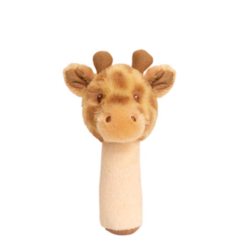 May include: A plush giraffe rattle featuring a soft, tan-colored cylindrical handle and a detailed giraffe head with brown spots, small ears, and two small brown horns on top. The toy is made of fuzzy fabric with embroidered facial features.