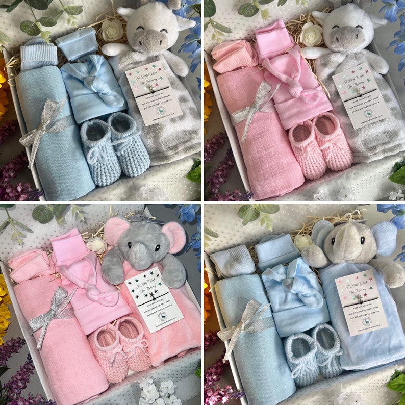 May include: Four gift boxes filled with baby items. Each box contains a plush animal, a blanket, a hat, a pair of socks, and a pair of booties. The boxes are decorated with ribbons and bows. The plush animals are a giraffe, an elephant, a giraffe, and an elephant. The blankets are blue, pink, blue, and pink. The hats are blue, pink, blue, and pink. The socks are blue, pink, blue, and pink. The booties are blue, pink, blue, and pink.