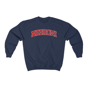 May include: A navy blue sweatshirt with the word "NEGRONI" printed in red on the front.