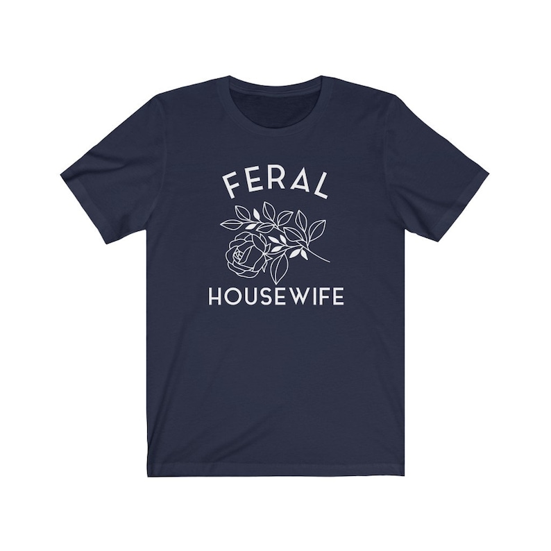 May include: Navy blue t-shirt with white text that reads "FERAL HOUSEWIFE" and a stylized white rose with leaves.