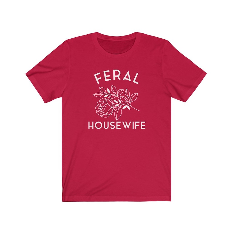 May include: Red short-sleeved t-shirt with white text that reads "FERAL HOUSEWIFE" and a stylized white rose.