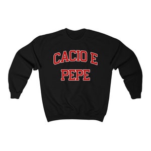 Puede incluir: Sudadera negra con texto rojo que dice "Cacio e Pepe" en una fuente universitaria.