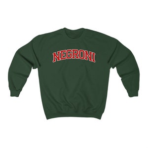 May include: A dark green sweatshirt with the word "NEGRONI" printed in red letters across the front.