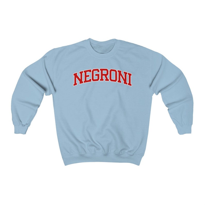 May include: A light blue sweatshirt with the word "NEGRONI" printed in red on the front.