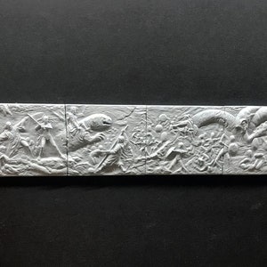 May include: A white, 3D printed wall sculpture depicting a scene from a science fiction movie. The sculpture is divided into five sections, each showing a different part of the scene. The scene includes a large, alien creature, a group of human characters, and a spaceship.