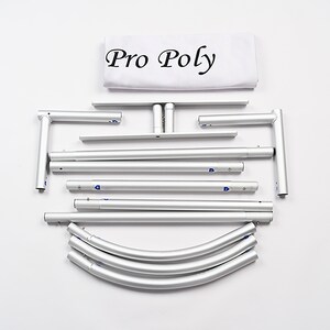 May include: A set of silver aluminum poles and connectors for a pop-up backdrop stand. The set includes straight poles, curved poles, and corner connectors. The white fabric backdrop is labeled "Pro Poly".