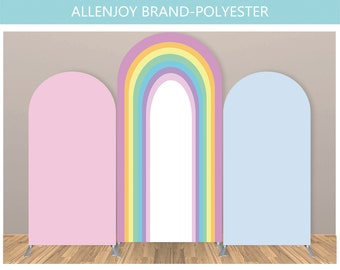 May include: Three arch-shaped backdrops for photography. The backdrop on the left is pink, the backdrop in the middle is a rainbow, and the backdrop on the right is light blue.