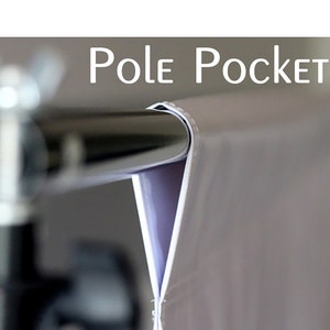 May include: Close-up of a white backdrop with a pole pocket sewn into the top edge. The pocket is designed to hold a backdrop stand.