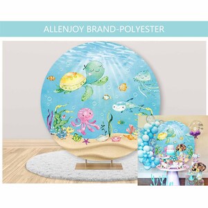 Może przedstawiać: Okrągłe, niebiesko-białe tło z akwarelową ilustracją żółwia, ośmiornicy i ryb. Tło idealnie nadaje się na baby shower lub przyjęcie urodzinowe.