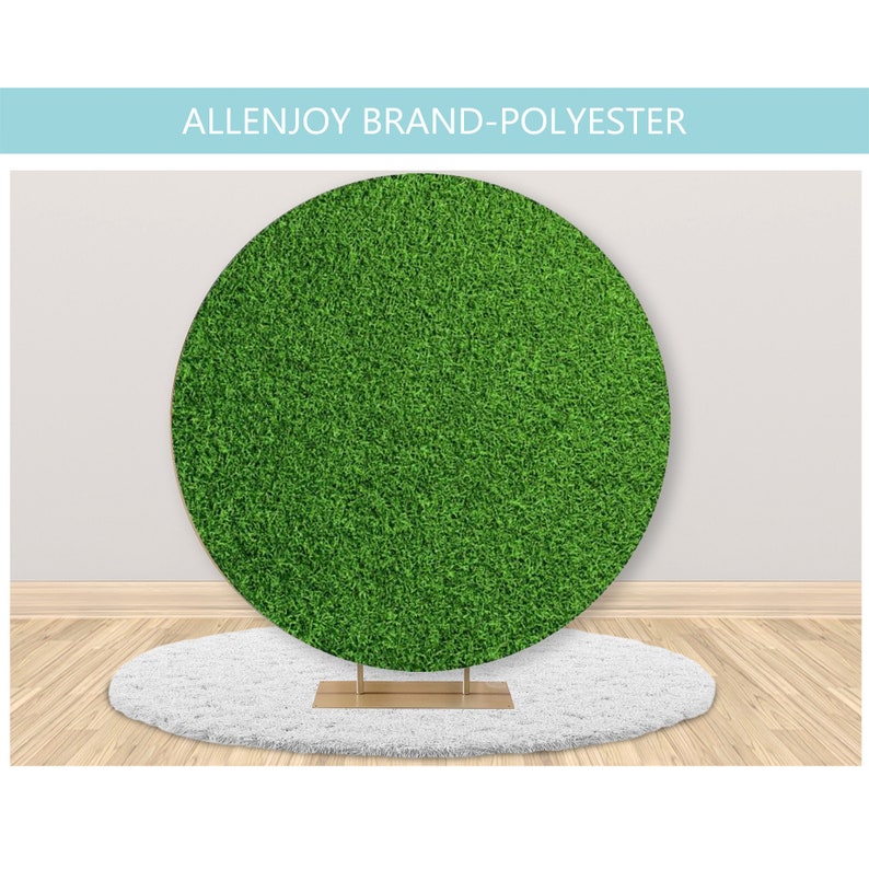 May include: A round green backdrop made of polyester fabric, resembling artificial grass. The backdrop is on a white fluffy rug and a gold stand.