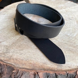 Sci-fi inspired brass buckle on full-grain leather belt.