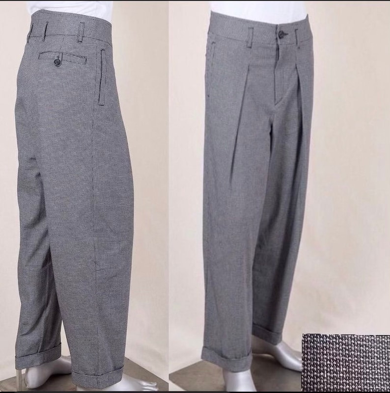 May include: Grey trousers with a checked pattern and pleats. The trousers have a cuffed hem and a button fly.