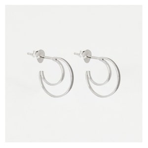 Crescent Moon Hoops. Sterling silver hoop earrings in the shape of a crescent moon.