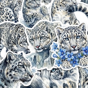 May include: A collection of watercolour-style stickers featuring snow leopards in various poses, including one resting among bright blue flowers. The leopards have white and grey fur with black rosettes, piercing blue eyes, and pink noses.