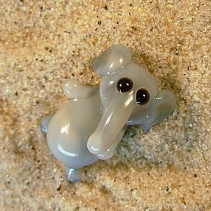 Elephant lying - glass animal / figurine, size approx. 17 - 20 mm, price for 1 piece, made in Czech Republic / no. 265