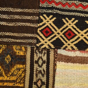 May include: A textile patchwork featuring various woven patterns. One section displays brown and white stripes, another shows a black background with yellow diamond shapes and red centers, and a third includes yellow and brown geometric motifs.
