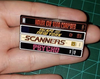 Vhs Movie Stack Enamel Pin series 1 featuring Psycho, scanners, escape from New York and House of 1000 corpses