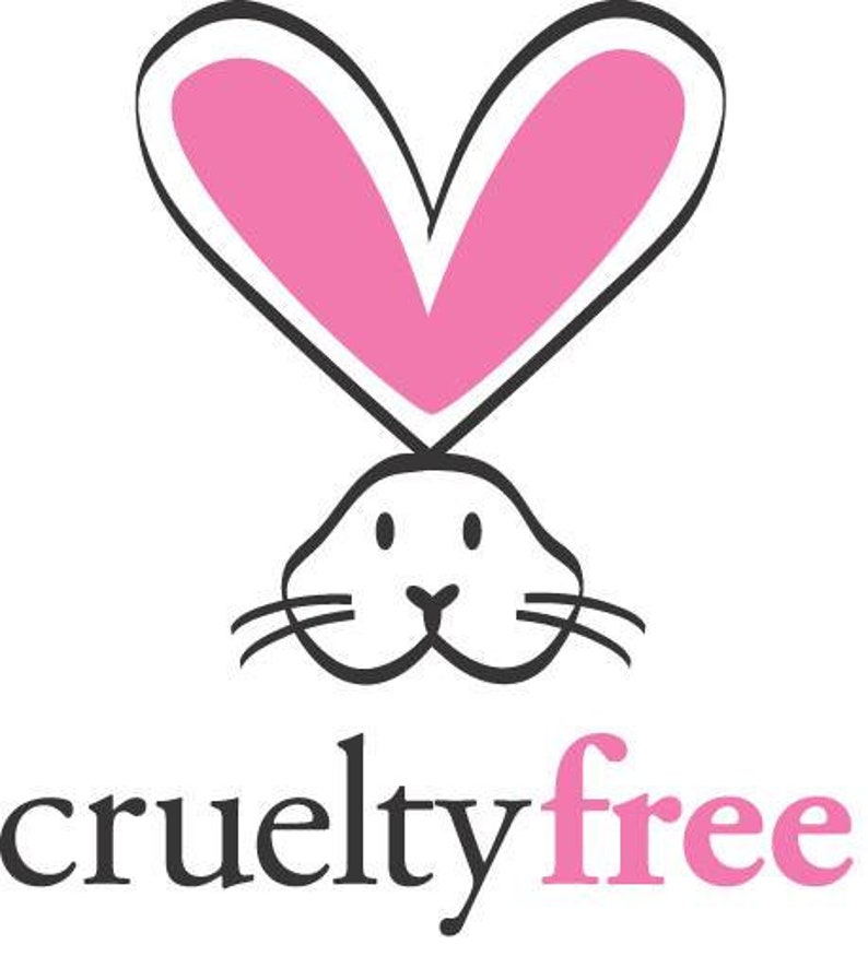 May include: A black and white illustration of a rabbit with pink ears shaped like hearts. The text "cruelty free" is below the rabbit, with "free" in pink.