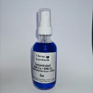 May include: A clear glass bottle with a white spray nozzle, filled with a vibrant blue liquid. The label reads "Chem Kardash" and "Concentrated AHK-Cu + GHK-Cu Peptide Hair Serum + Caffeine, 2oz". The bottle is on a white background.