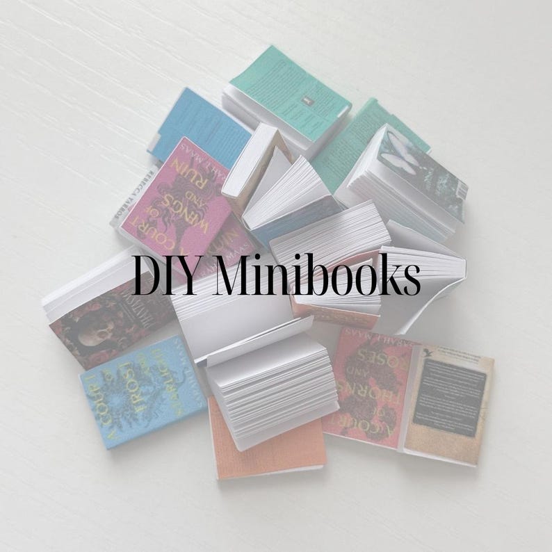 May include: A selection of small books in shades of blue, green, and pink, with text visible on the covers. The words "DIY Minibooks" are displayed in the centre. The books are arranged on a white surface.