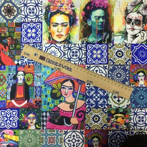 May include: A colorful fabric with a patchwork design featuring various images of Frida Kahlo, including one with a black cat and an umbrella. The fabric also includes blue and white tile patterns and a ruler measuring 30 cm.