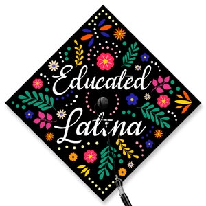 May include: Black graduation cap with a colorful floral design and the text "Educated Latina" in white.