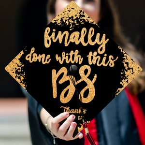 May include: Black graduation cap with gold glitter and the text "finally done with this BS" and "Thanks Dad".