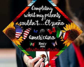 May include: A black graduation cap with the text "Completing what my parents couldn't... El sueño americano" and the name "Emily 2023". The cap features butterflies with American, Italian, and Mexican flag designs, and sunflowers.