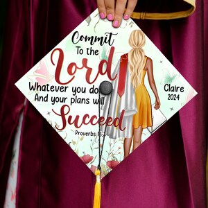 May include: A white graduation cap with a floral design and a woman in a yellow dress and a white graduation gown. The text on the cap reads "Commit to the Lord Whatever you do And your plans will Succeed Proverbs 16:3" and "Claire 2024".