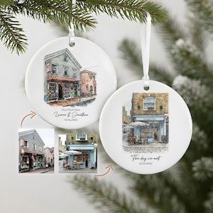 May include: Two white ceramic Christmas ornaments with watercolor illustrations of buildings. One ornament says "Our First Date" and the date. The other says "The day we met" and the date.
