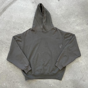May include: A dark gray hoodie with a hood and long sleeves. The sweatshirt has a small, faded design on the chest. The garment is made of a soft material and is suitable for casual wear.