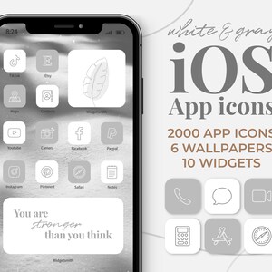 Op de afbeelding: Een wit en grijs iPhone-scherm met een verzameling app-pictogrammen. De pictogrammen zijn in een rasterpatroon gerangschikt en omvatten apps zoals TikTok, Etsy, Maps, Contacten, YouTube, Camera, Facebook, Paypal, Instagram, Pinterest, Safari en Notities. Het scherm bevat ook een citaat dat zegt "Je bent sterker dan je denkt." De achtergrond van het scherm is een wazig beeld van een wit en grijs landschap.