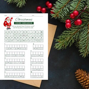 May include: A printable Christmas code breaker activity sheet featuring a Santa Claus illustration. The sheet includes a letter grid with matching Christmas-themed symbols, and a numbered grid for decoding words.