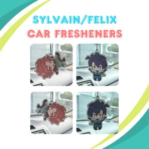 May include: Four car air fresheners featuring cartoon characters. Two fresheners show a character with red hair and a green outfit, while the other two depict a character with dark blue hair and a teal outfit. The text "SYLVAIN/FELIX CAR FRESHENERS" is at the top.