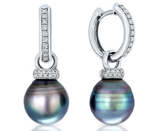 May include: A pair of silver hoop earrings with a black pearl drop. Each earring features a silver hoop with a row of small diamonds and a silver pendant with a row of small diamonds and a black pearl.