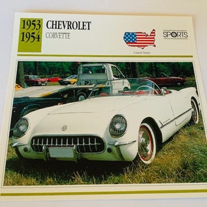 May include: A white 1953-1954 Chevrolet Corvette sports car with a red interior. The car is parked on a grassy area with other cars in the background. The image is from a vintage car card with the text "1953 1954 CHEVROLET CORVETTE" and "SPORTS" printed on it.