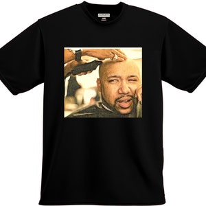 May include: A black and white illustration of a man getting a haircut. The man has a beard and is looking at the camera. The barber is holding a pair of clippers.