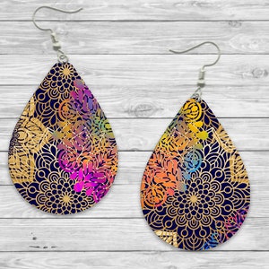 May include: A pair of teardrop-shaped earrings with a gold and colorful mandala design. The earrings are made of a dark blue material and have silver hooks.