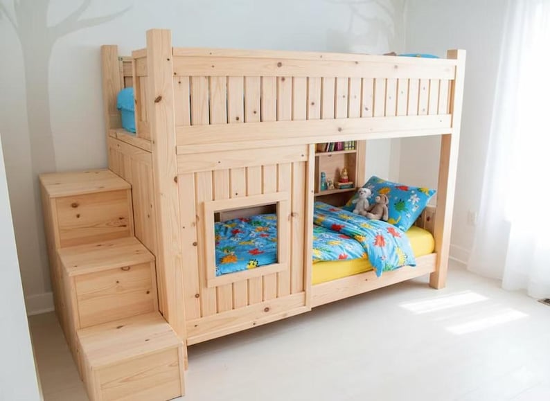 May include: A light-colored wooden bunk bed with a built-in staircase. The bed has a window and a small bookshelf. The bedding includes a yellow sheet, a blue comforter, and a blue pillow with a cartoon design.