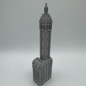 May include: A detailed gray model of a tall, ornate building with a domed roof.