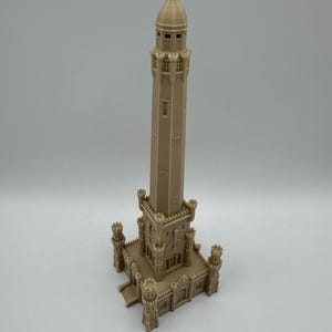 May include: A beige 3D-printed model of a tall tower with a domed top and multiple levels. The tower has a rectangular base with decorative elements, including small turrets at each corner. The model is detailed and stands on a white surface.