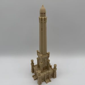 May include: A tan-colored miniature replica of a tall, ornate tower. The tower features a detailed base with multiple levels, turrets, and arched windows. The tower's design includes a tall, slender central structure with a domed top.