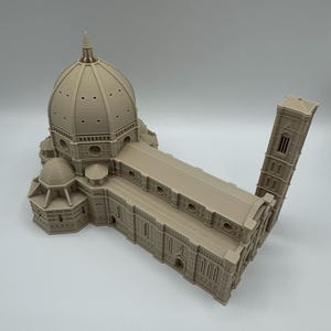 May include: A beige architectural model of a cathedral, featuring a large dome, rectangular structure, and a tall bell tower. The model is a detailed replica of a famous landmark.