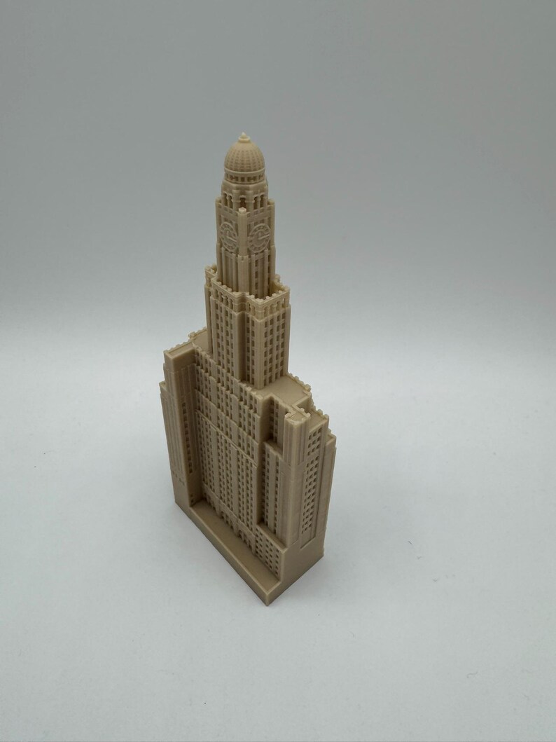 May include: A beige 3D printed model of a tall building with a clock tower and a domed roof.