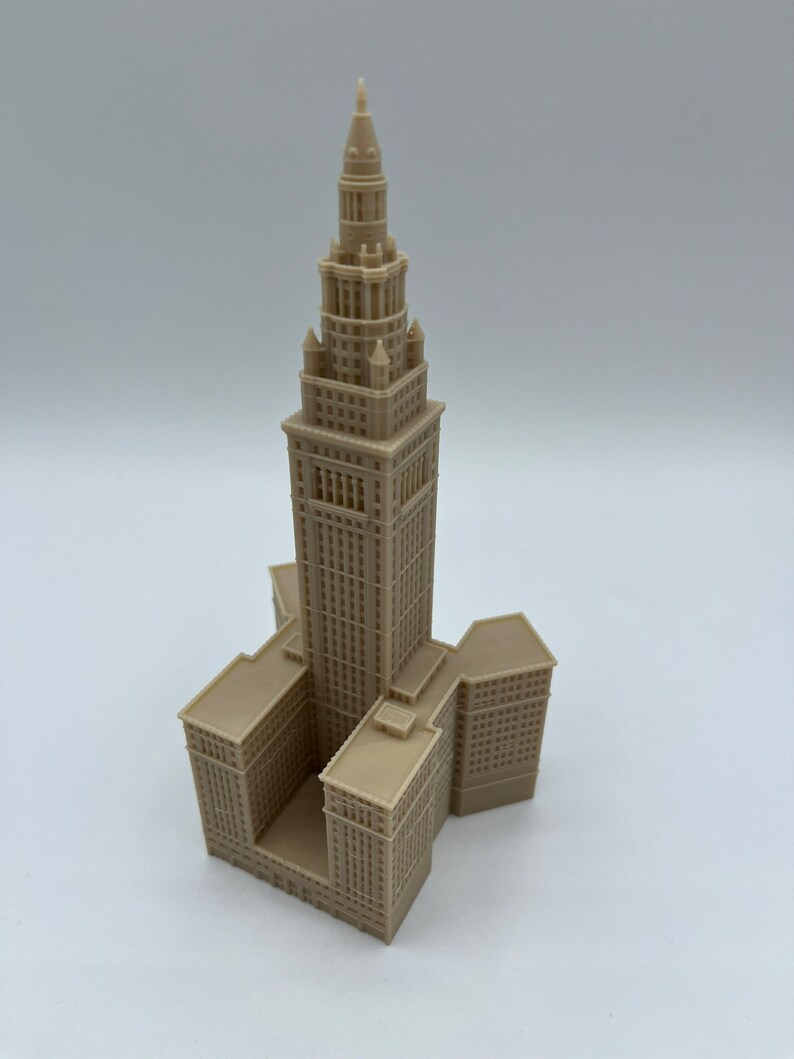 May include: A beige 3D printed model of the Terminal Tower in Cleveland, Ohio. The model is detailed and includes the tower's distinctive spire and surrounding buildings.